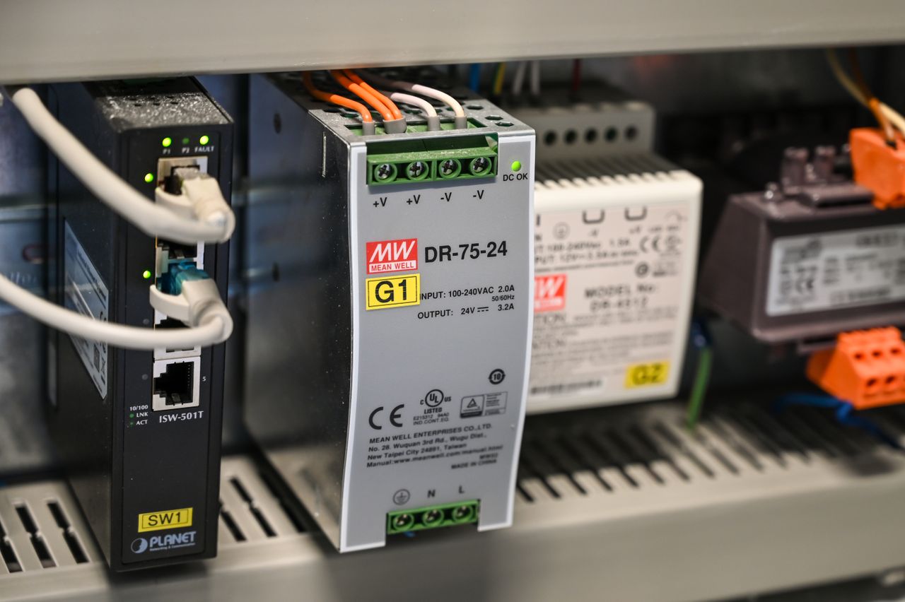 About Close-up of electronic components and wires inside industrial equipment.